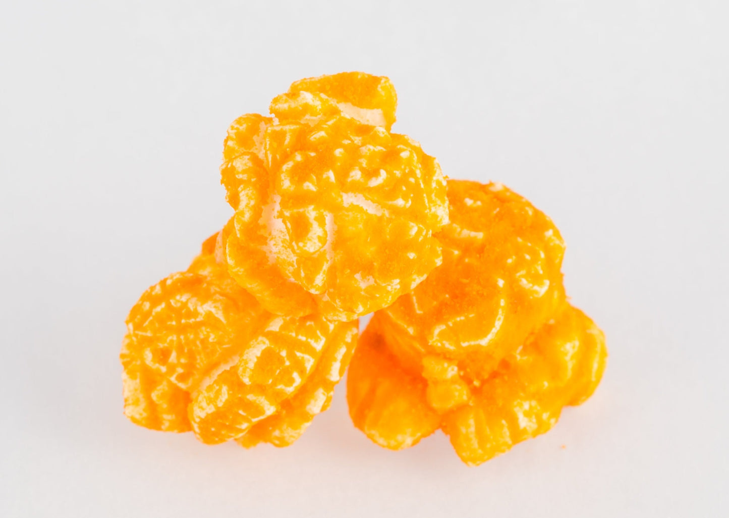 Three kernels of cheese-covered popcorn.