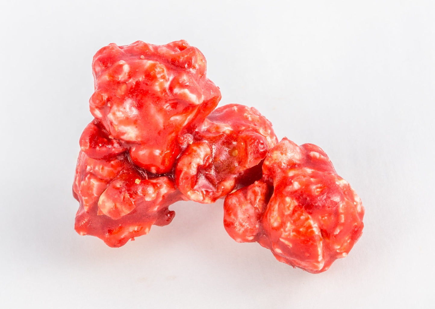Two pieces of popped popcorn covered in cinnamon.