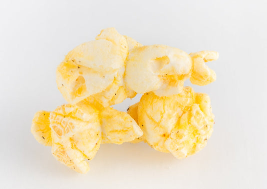 Three pieces of cheese-covered popped popcorn kernels.