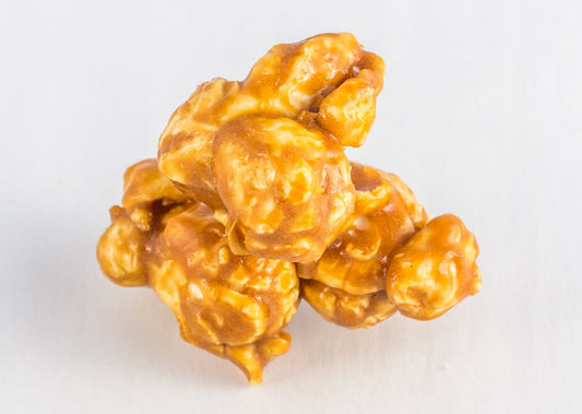 Three pieces of caramel-coated popped popcorn kernels.